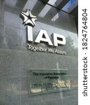 Small photo of The insurance association of Pakistan (IAP) logo on a black tile wall outside their office - Karachi Pakistan - Sep 2020