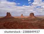 View of the West Mitten Butte, East Mitten Butte and Merrick Butte red sandstone formation in Monument Valley, AZ