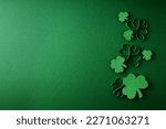 Saint Patrick day flat lay concept with shamrock clover on green background, top view, copy space