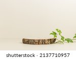 Empty wooden podium with green ivy leaves, display for eco-friendly, organic product presentation, neutral beige background