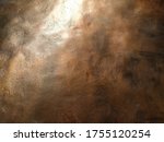 Copper texture background. Bronze texture. Bent metal with dents. Close-up of a bronze surface. A reflection of light in a bent place