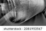 Small photo of Metal mesh. Rolled mesh in gray. Heavy duty steel or aluminum mesh with ragged edges