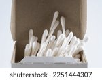 Q-tips  cotton buds with cardboard sticks in retail cardboard carton with open lid isolated on a white background