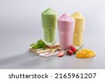 Small photo of Smoothies ice blended mixed fruits mango strawberry avocado with fresh fruits decoration on white background. Summer tropical Smoothies juice Drinks Smoothie mixer blending fruit