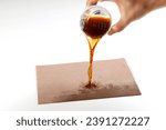 Small photo of Fabric absorb Liquid stain dirty splashing on floor. Tea or coffee water stain splash seepage on white background. Cloth absorbent cleaning liquid stain pouring out on white table surface