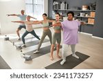 People exercising with instructor in class