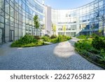 Small photo of Modern round office building with garden