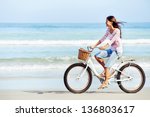 Carefree woman with bicycle...