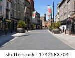 Small photo of CARDIFF / WALES MAY 25 2020: COVID 19 retail sector continues in lockdown, the roads are empty, shops closed, just cyclists using the desolate roads and precincts for exercise.