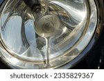 Small photo of Barry Island, Vale of Glam, Wales - June 11 2023: Close-up of the spotlights on a vintage Rolls-Royce in a classic car exhibition. The brand still symbolises luxurious and affluence.