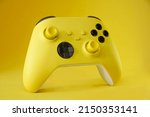 Yellow game controller on Yellow background