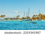 Turquoise colored sea with ancored yacht and boats, Tobago Cays, Saint Vincent and the Grenadines, Caribbean sea
