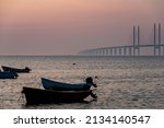 Small photo of Romantic southern Sweden: Cozy Oresund Bridge detail at dusk with small boats. Close connection between Malmo and Copenhagen. Profound or deep link or bound illustration. Country boundaries or borders