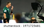 Small photo of TURIN, ITALY - May 9, 2021: The referee Paolo Valeri checks with the VAR monitor before awarding AC Milan a second half penalty during the Serie A 2020-2021 JUVENTUS v MILAN at Allianz Stadium.