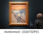 Small photo of Oslo, Norway, June 20, 2023: A tourist observes the famous Edvard Munch composition The Scream at the National Gallery.