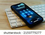 Small photo of locked Apple iPhone with keyboard on wooden table, close-up. request to access code enter to device Russian language interface of Apple smartphone. enter passcode 10.16.2019 Kyiv, Ukraine