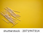 Wooden toothpicks on light background. place for text