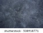 Dark stone or slate wall.Grunge background.