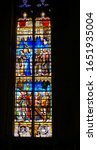 Small photo of Toulouse, France - Jan. 2020 - Brightly coloured stained glass window in the Cathedral of Saint Stephen (Saint-Etienne) picturing religious scenes involving clergymen, Biblical and historical figures