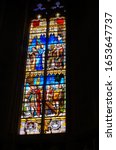 Small photo of Toulouse, France - Jan. 2020 - Colorful stained glass window in the Cathedral of Saint Stephen (Saint-Etienne) picturing religious scenes involving clergymen, Biblical and historical characters