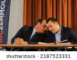 Small photo of Chalons-en-Champagne, France - April 2022 - Town councillors Thomas Adnot, entrepreneur, legislative candidate for Reconquete, and Freddy Perin, alternate candidate, talk together during a meeting