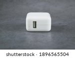 Small photo of Taipei,Taiwan-Jan 11 2021:Apple adapter for iPhone,10W USB power adapter on grey background