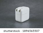 Small photo of Taipei,Taiwan-Jan 11 2021:Apple adapter for iPhone,10W USB power adapter on grey background