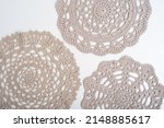 Light brown crochet doilies on a white background