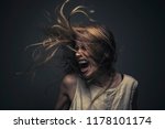 Small photo of Crazy, deranged young woman screaming with frustration, expressing madness and rage