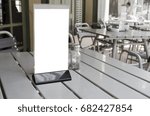 Blank space of information label stand on the table cafe, restaurant background