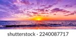 Small photo of A Divine Surreal Colorful Ocean Sunset With Sun Rays In Banner Image Format