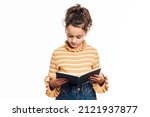 Young girl reading a book while ...