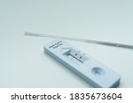 Negative SARS-CoV-2 Rapid Antigen Test isolated on white background with nasal swab stick