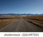 Backcountry dirt gravel road Braemar Road leading to Lake Pukaki, Southern Alps mountain nature landscape panorama in Mackenzie County Canterbury South Island New Zealand