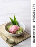 Small photo of Putu Mayang or Petulo, Indonesian Traditional Javanese Snack Made of Rice Flour Strands Curled up into a Ball with Food Coloring, Served with Coconut Milk and Palm Sugar Syrup. White Background
