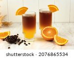 Iced Orange Espresso Coffee Mocktail Cold Brew Tonic Spritz on White Background, Concept Menu for Coffee Shop