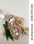Small photo of Tang Yuan (Wedang Ronde), Chinese Glutinous Rice Dumpling Balls with Sugar Ginger Syrup on Red Chinese on Red Background for Winter Solstice New Year or Lantern Festival Food. Copy Space
