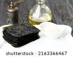 Small photo of Selected Focus Crispy Salted Nori Laver Sheet on White Plate, Popular in Japan and Korea for Sushi and Kimbap