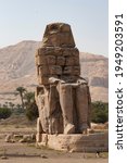 Small photo of Colossi of Memnon - the ancient guardians of the temple of Amenhotep III at the entrance to the nonexistent ruined burial temple, the city of the dead Luxor
