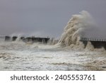 Small photo of Huge Waves battering a sea defence wall during a storm at Hartlepool Headland, County Durham, England, UK.