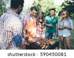 Happy people having camping and having bbq party outdoor