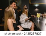 Small photo of KYIV , UKRAINE - SEPTEMBER 27 2023: Ladies have cocktail evening accompanied by handsome gentlemen. Youth partake in entertaining program in local restaurant