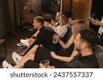 Small photo of KYIV , UKRAINE - SEPTEMBER 27 2023: Friends celebrate victories and joy of gaming camaraderie. Game room resonates with sounds of laughter and friendly banter