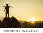 Small photo of silhouette of boy scout activities studying mountain nature and camping