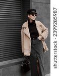 Small photo of portrait of beautiful girl dressed in black denim midi skirt with slit, collared sweater, cap, bag, sunglasses, beige sheepskin coat, stylish fashion outfit, lifestyle model