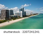 6767 Collins Ave APT 1110, Miami Beach
Drone view, miami beach with buildings in the background, beautiful blue sky and beach, waves, vacation