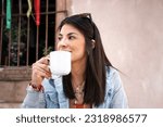 close up portrait of woman enjoying her coffee in outdoor restaurant