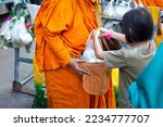 Small photo of Thai monk ask for alms in morning for buddhist to make merit to offer food to the monks and receive blessing from the monks