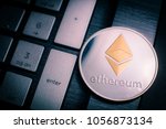 Ethereum cryptocurrency (crypto currency). Silver Ethereum coin with gold Ethereum symbol on a laptop keyboard next to the Enter key