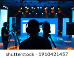 Professional cameraman - covering on event with a video, cameraman silhouette on live studio news, Selective focus